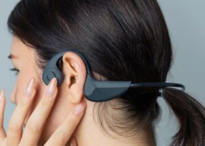 Woman using bone-conduction headphones for sound therapy